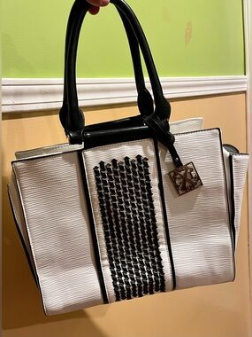 Christian Lacroix handbag in white and black, with gold zipper accents.